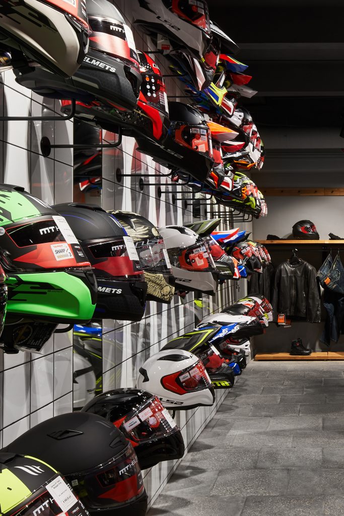 Интерьер мотосалона с идеальным мерчандайзингом мотошлемов и специальные крючки для крепления шлемов.